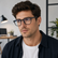 Model wearing Keystone Blue Light Glasses in a natural lifestyle setting